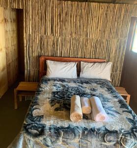 a bed with two rolled up towels on it at Emms Cubango Ecological Camp in Divundu