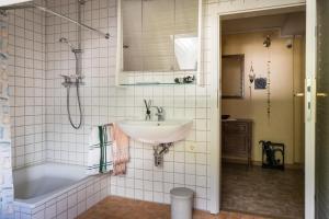 a bathroom with a sink and a bath tub at Villa Robert Heuser in Traben-Trarbach +4 photos