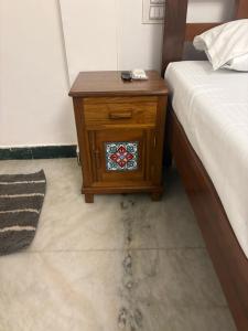 a nightstand with a stained glass window on it next to a bed at Rainbow721 Earth in Pondicherry