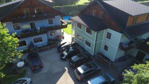 an aerial view of a house with cars parked in a parking lot at Pension Sydler in Bad Goisern