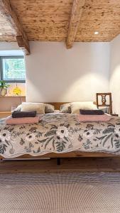 a bedroom with a large bed in a room at Cavigliano Rustico - free parking in Cavigliano
