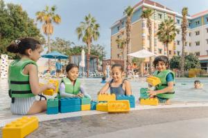 three children playing in the water at a resort at LEGOLAND Hotel Dubai in Dubai