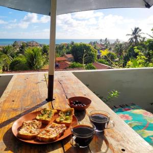 a plate of food on top of a wooden table at Casa de Mar - Praia do Sagi in Baía Formosa