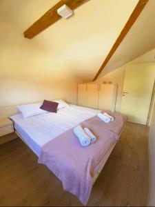 two beds in a room with towels on them at Pure Sky Apartments - with pool in Mostar
