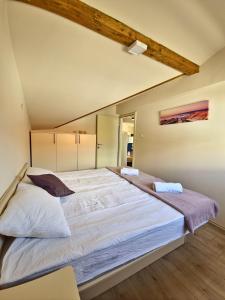 a large bed in a room with a large at Pure Sky Apartments - with pool in Mostar