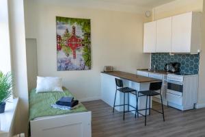 a small kitchen with a bed and a table at Grand Jugend Studio in Kallio in Helsinki