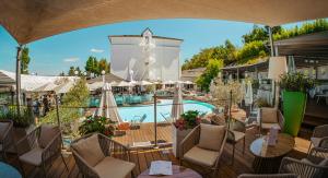 a view of a resort with a swimming pool at Hotel Du Golf in Saint-Étienne