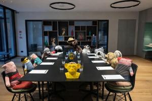 a group of stuffed animals sitting around a table at Hotel Giardino Verdi in Riva del Garda