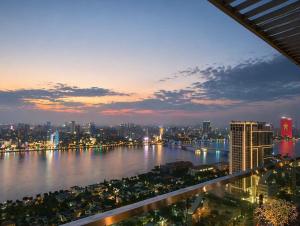 a view of a city at night with a river at Monarchy Luxury Serviced Apartments - By Charm Homestay Vietnam in Danang
