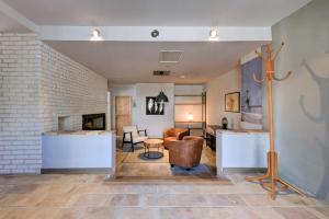a living room with a couch and a fireplace at La Pause Camarguaise in Saint-Laurent-dʼAigouze