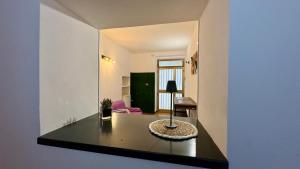 a room with a table with a lamp on it at Casa Vacanze "La Casetta" in Configni
