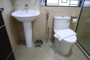 a bathroom with a toilet and a sink at Pearl Serenity in Sholāshahar