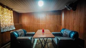 a conference room with a table and leather chairs at Redwing Peaceful Studio in Navi Mumbai +10 photos