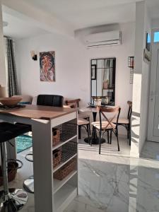 a kitchen and dining room with a table and chairs at MiLA - Hladna Uvala in Utjeha