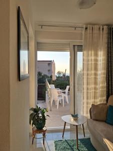 a living room with a couch and a table at MiLA - Hladna Uvala in Utjeha