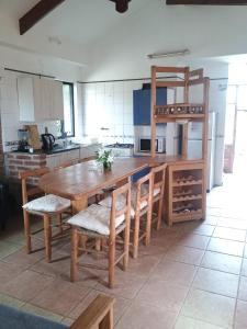 a large kitchen with a wooden table and chairs at Ilocavistamar in Iloca