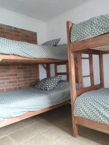 a room with three bunk beds in a room at Ilocavistamar in Iloca