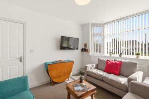 a living room with a couch and a table at 4BR with Private Parking in Wyken