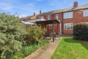 a brick house with an awning in the yard at 4BR with Private Parking in Wyken