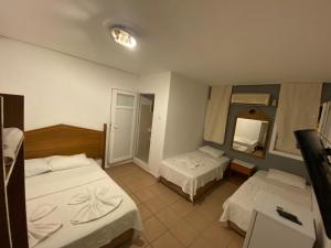 a hotel room with two beds and a mirror at denge pansiyon in Datca