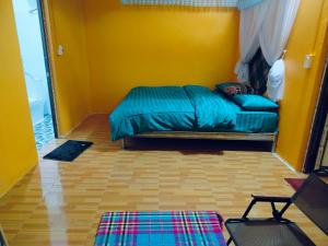 a bedroom with a bed in a yellow room at Cổng Trời Homestay in Ha Giang