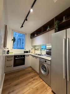 a kitchen with a refrigerator and a dishwasher at Golf Residence Suite & pool in Eilat