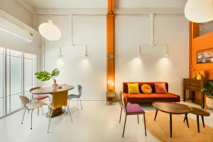 a living room with a table and a couch at Industrial Loft Sukhumvit 3-Bedroom Designer House - 2 Min to BTS Bang Chak in Bangkok