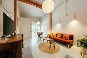 a living room with a couch and a table at Industrial Loft Sukhumvit 3-Bedroom Designer House - 2 Min to BTS Bang Chak in Bangkok +52 photos