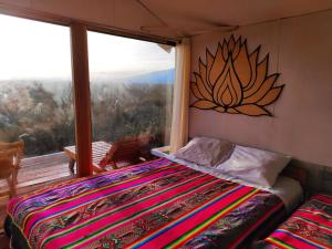 a bedroom with a bed and a large window at Los Uros in Puno