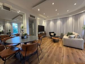a living room with a table and a couch at Golf Residence Suite & pool in Eilat
