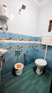 a bathroom with a toilet and a sink at Redwing Peaceful Studio in Navi Mumbai