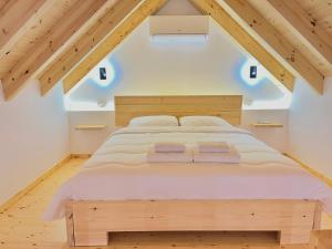 a bedroom with a large bed in the attic at Rosea LOFT in Përmet