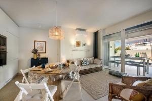 a living room with a table and a couch at Casas do Forte by MY CHOICE in Tavira