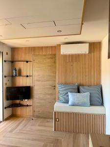 a bedroom with a bed with a wooden wall at Bernard l'Hermite Studio in Gruissan