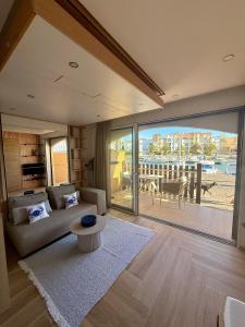 a living room with a couch and a large window at Bernard l'Hermite Studio in Gruissan +3 photos