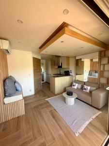 a living room with a couch and a table at Bernard l'Hermite Studio in Gruissan