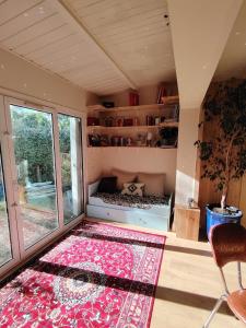 a room with a bed and a rug and a window at Maison La Séréna in Arès +9 photos