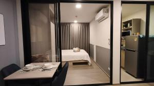 a small room with a table and a refrigerator at Eden D condo reefB244 in Kathu