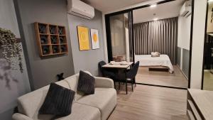 a living room with a couch and a table at Eden D condo reefB244 in Kathu +25 photos