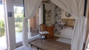 a bedroom with a bathroom with a sink and a window at une halte templière in Trouillas