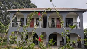 an exterior view of a house with red doors at Karibu Resort Sipi in Kapchorwa