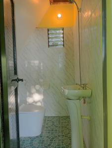 a bathroom with a sink and a toilet and a tub at Thornton's Sea View Cafe & Guesthouse in Siquijor +116 photos