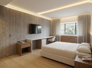 a bedroom with a bed and a desk and a television at Viale Jardins in Foz do Iguaçu