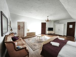 a living room with a couch and a table at Lesence Major in Lesencetomaj