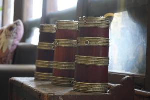 three stacks of books sitting on top of a table at Kingaling Hotel in Punākha +1 photo