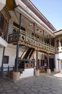 a building with a balcony and a staircase on it at Kingaling Hotel in Punākha