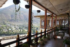 a room with a view of a mountain at Kingaling Hotel in Punākha