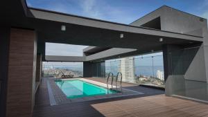 a swimming pool in a building with a view at Marina Dunas in Viña del Mar