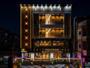 a building with lights on the side of it at Pavitram Hotel & Banquet in Rānchī