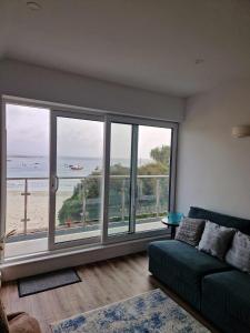 a living room with a couch and a view of the beach at Beachview Rental in Clare Island